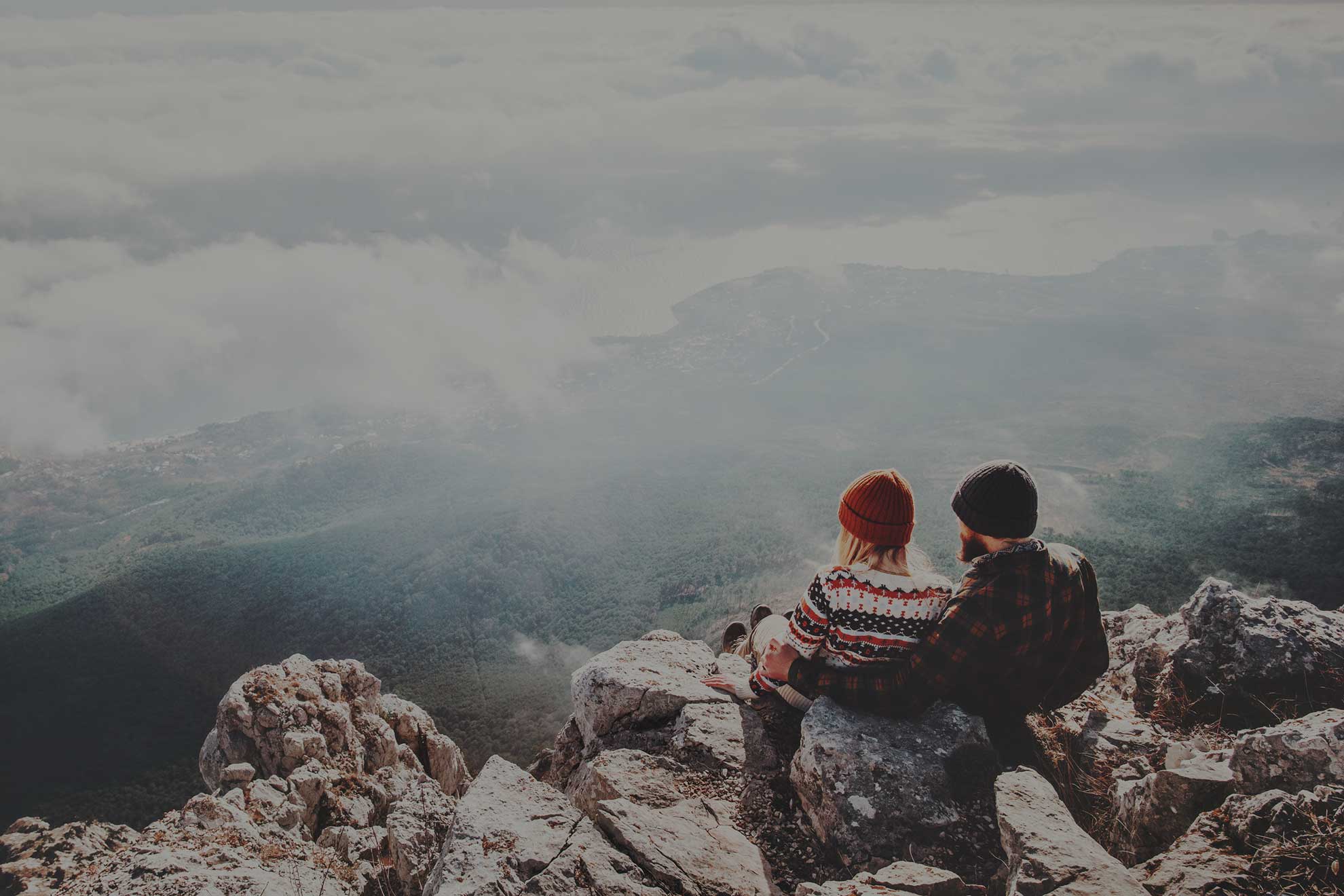 couple sitting on cliff edge